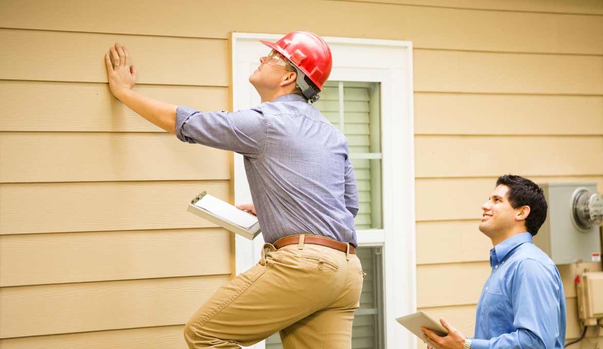 man getting house inspected to make improvements and repairs before selling house